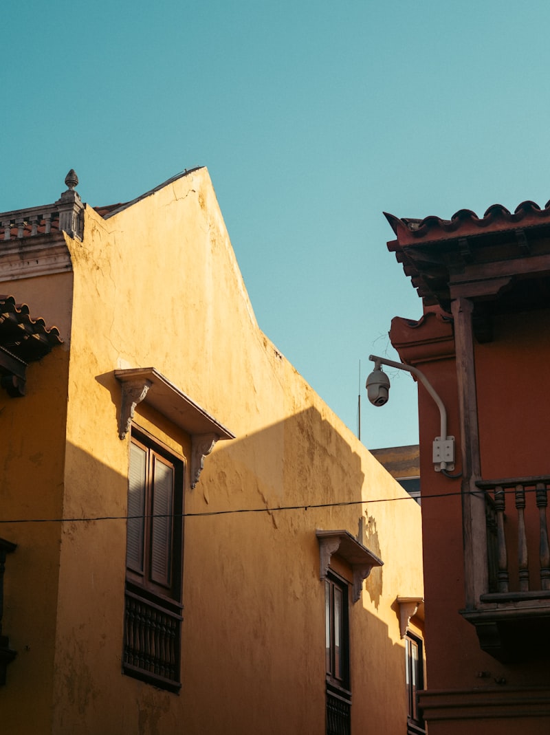 Old yellow and reddish-brown buildings under a clear blue sky.